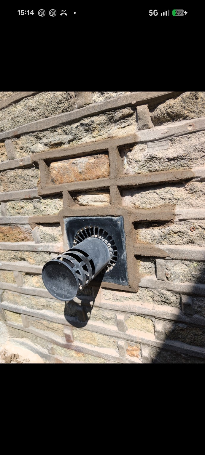 Stone wall repointing around an external vent